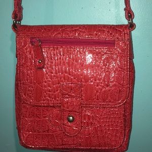 Pink leather type cross body bag